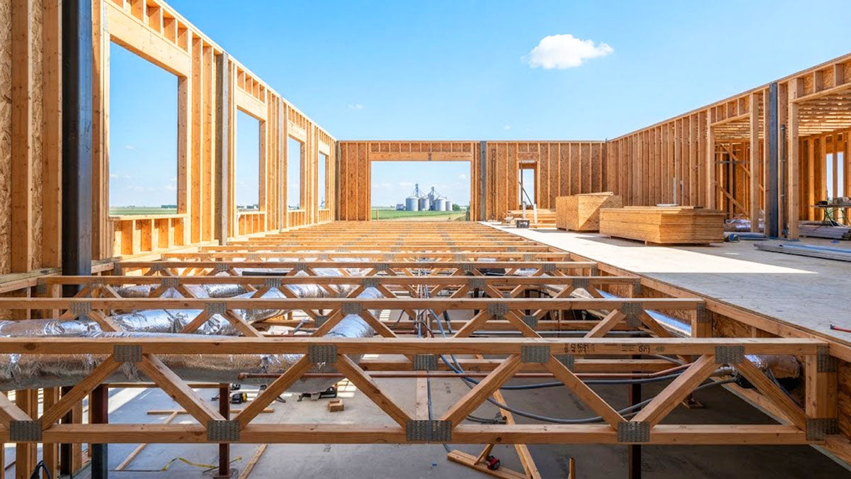 Open-web timber floor trusses installed on a commercial construction site in Kansas.
