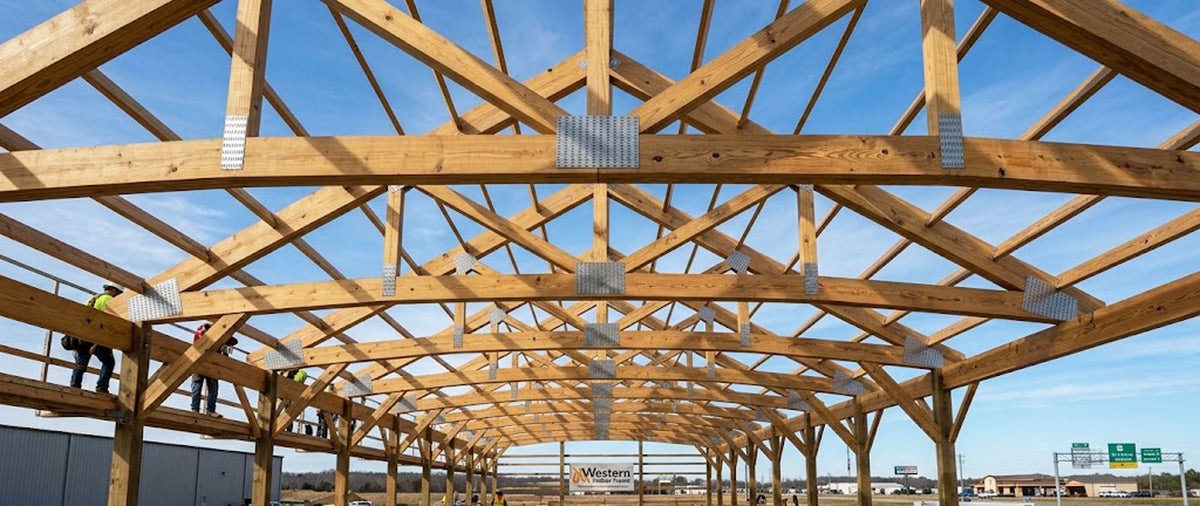 Clear-span Southern Yellow Pine engineered roof trusses framed on a commercial jobsite in Arkansas.
