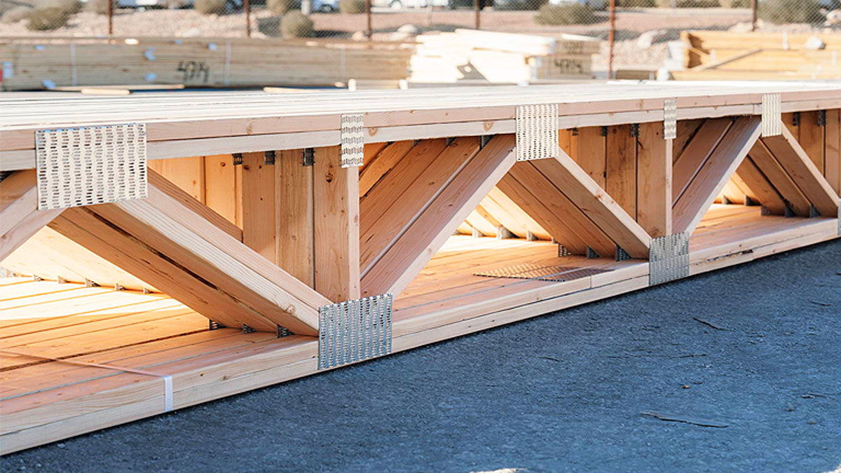 Open-web timber floor trusses installed on a commercial construction site in Alabama.