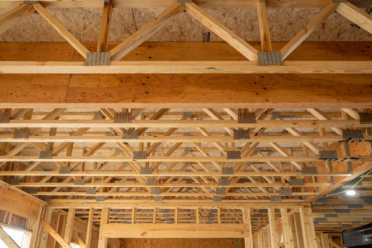 Open-web timber floor trusses installed on a commercial construction site in Arkansas.