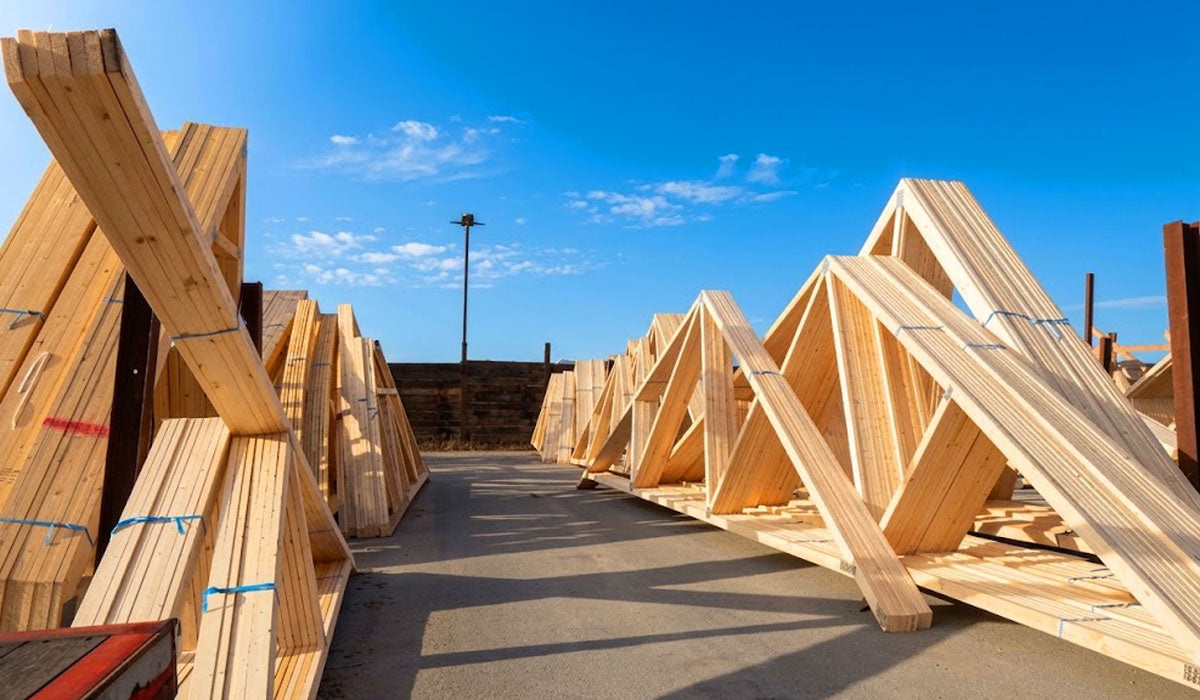 Heavy-duty Southern Yellow Pine engineered roof trusses with galvanized plates staged in Beaumont, TX.