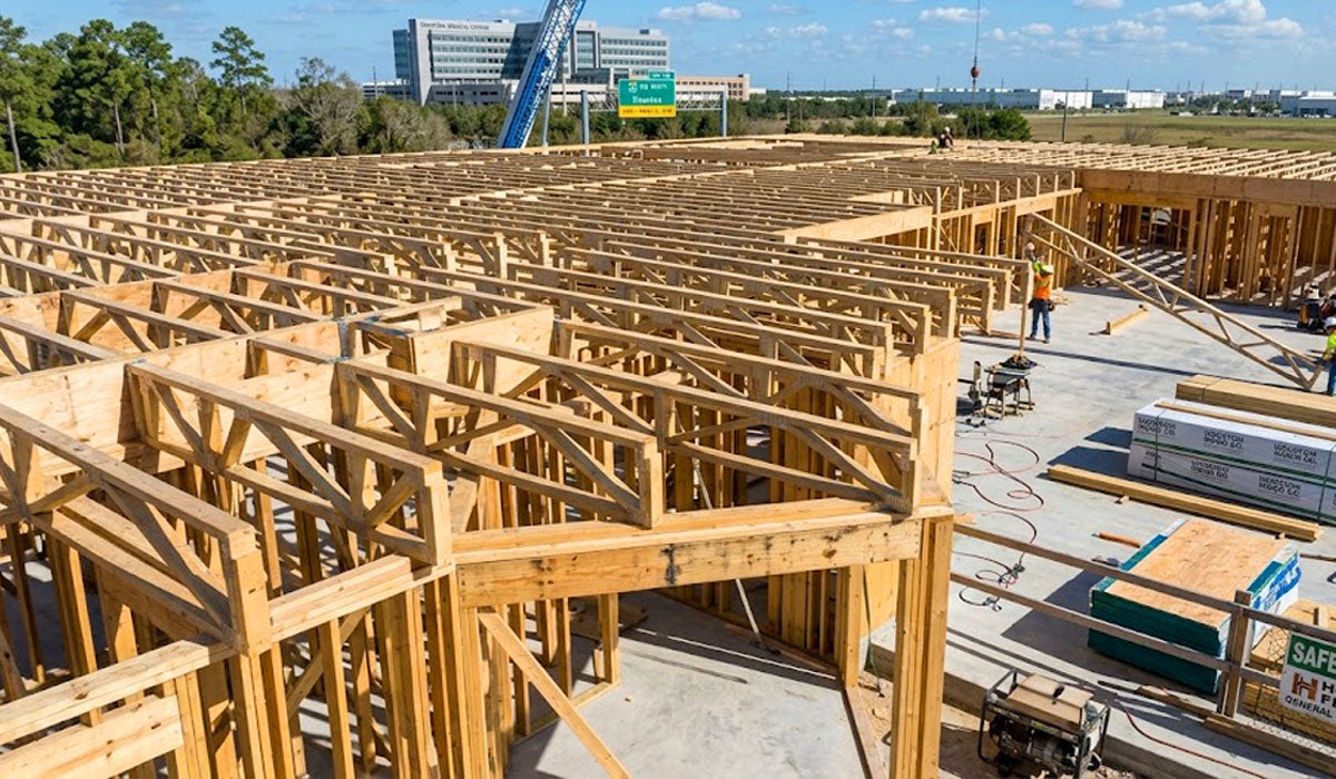 Open-web timber floor trusses installed on a multi-family framing site in Brazos County, Bryan, Texas.
