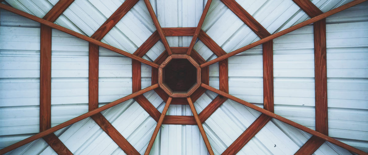 Clear-span Southern Yellow Pine engineered roof trusses framed on a commercial jobsite in California.