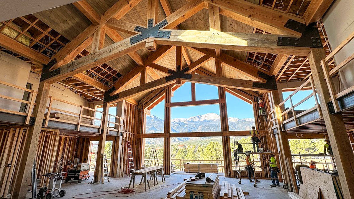 Vaulted scissor timber roof trusses installed in a custom mountain estate near Colorado Springs, Colorado.