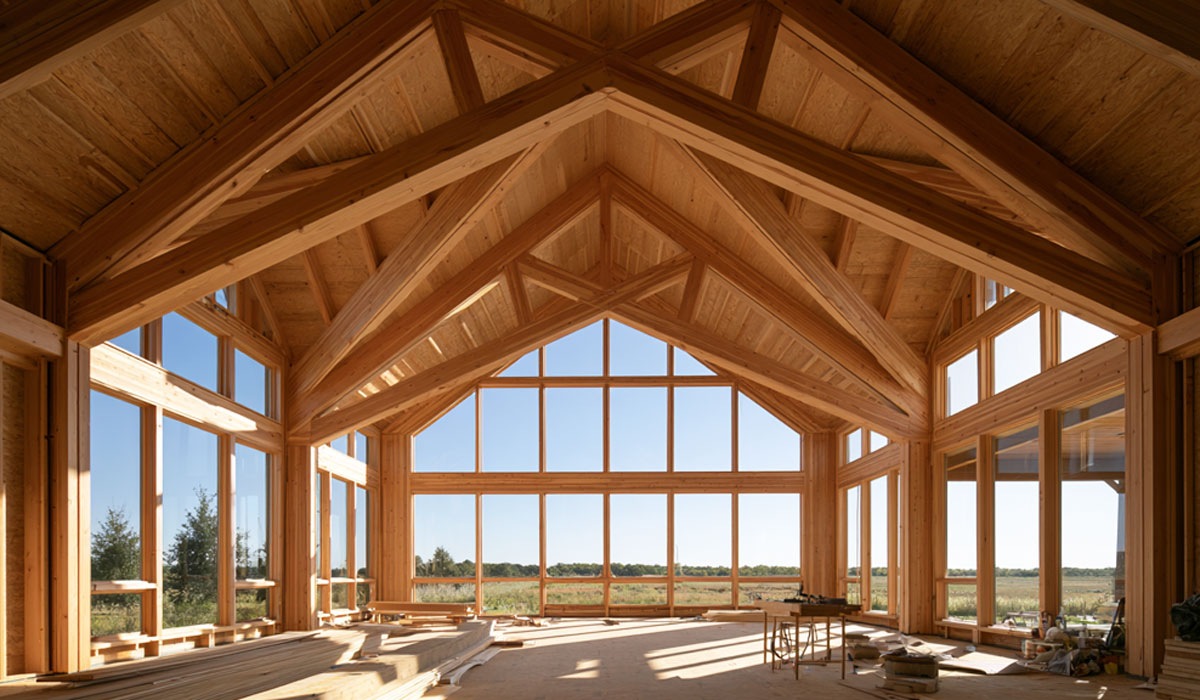 Vaulted scissor timber roof trusses installed in the high-ceiling great room of a custom ranch home in Kurten near Bryan, TX.