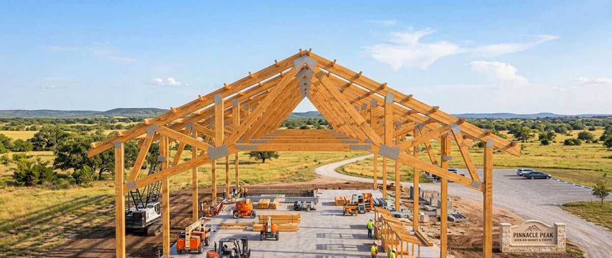 Clear-span Southern Yellow Pine engineered roof trusses framed on a commercial jobsite in Louisiana.