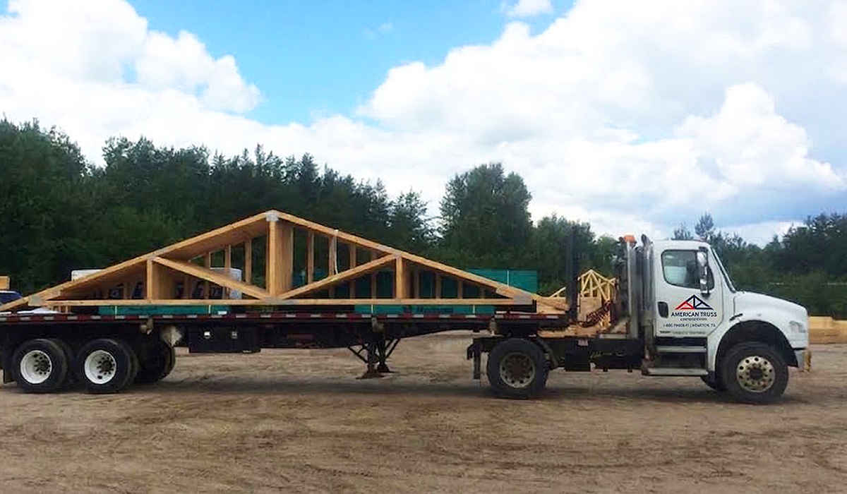 Flatbed truss delivery truck serving Plano and Collin County construction jobsites