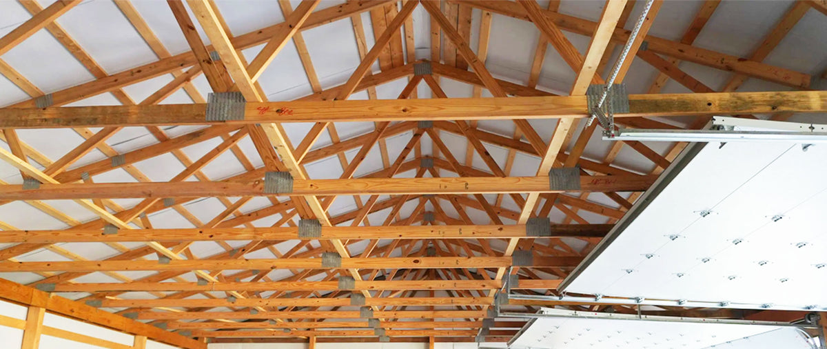 Clear-span Southern Yellow Pine engineered roof trusses framed on a commercial jobsite in Mississippi.