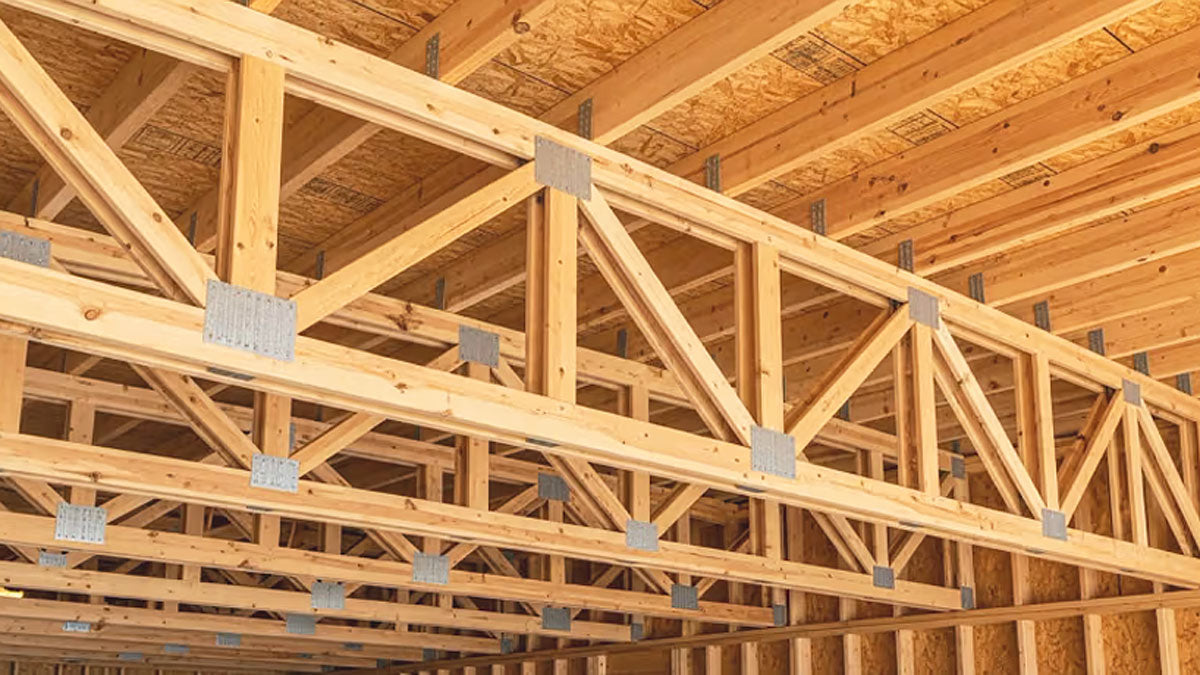 Open-web timber floor trusses installed on a commercial construction site in Mississippi.