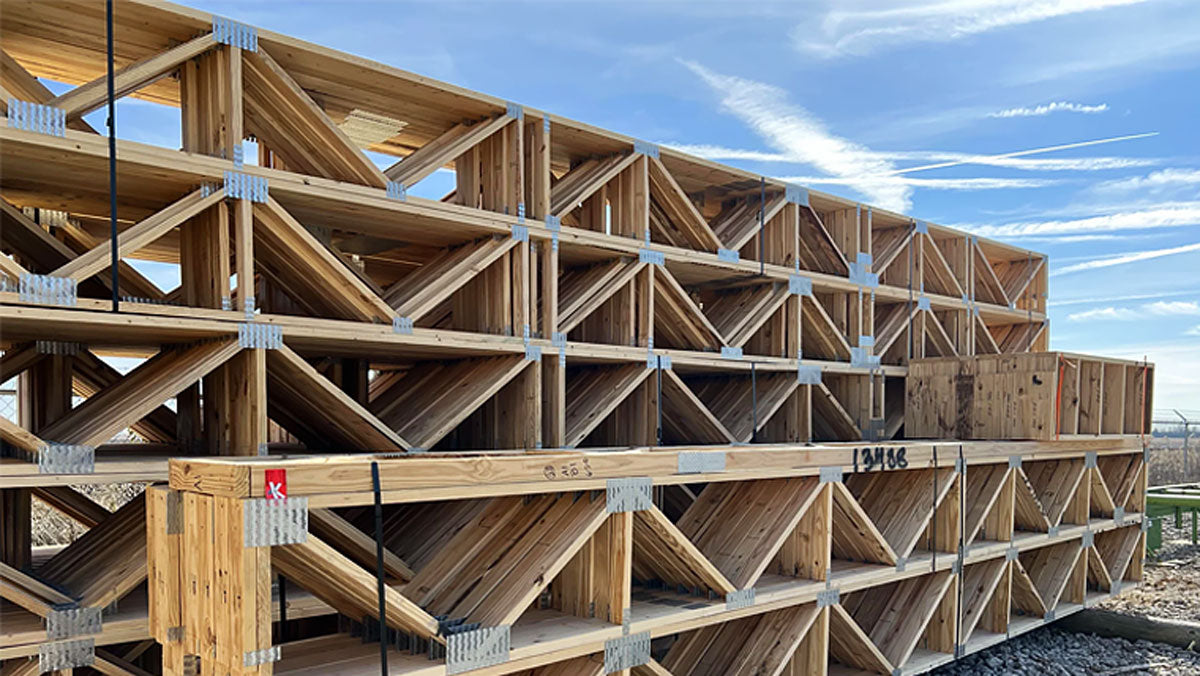 Open-web timber floor trusses installed on a commercial construction site in New Mexico.
