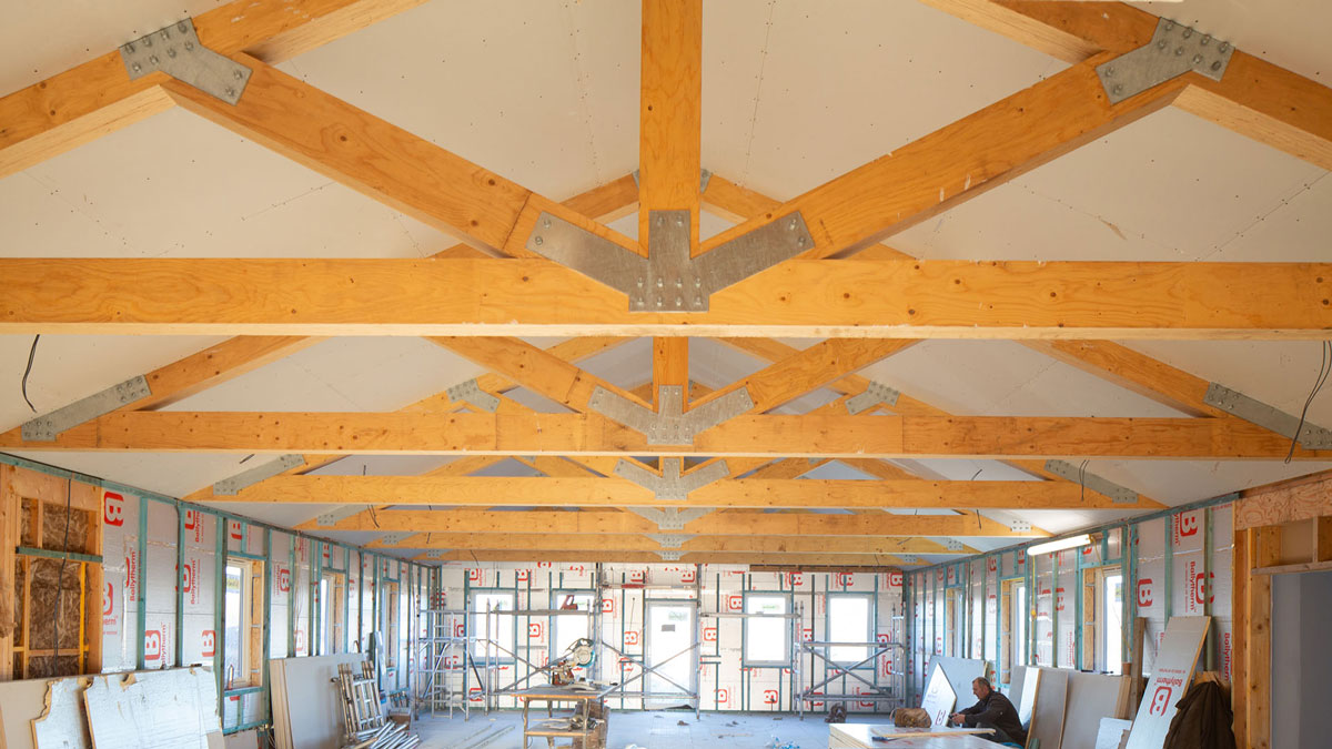 Vaulted scissor timber roof trusses installed in a custom mountain estate in Arkansas.
