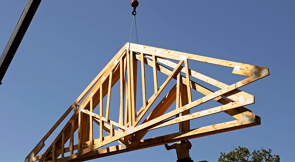 Crane unloading roof trusses at a North DFW construction jobsite