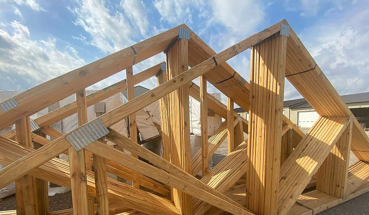 Heavy-duty Southern Yellow Pine engineered roof trusses with galvanized plates staged in Port Arthur, TX.