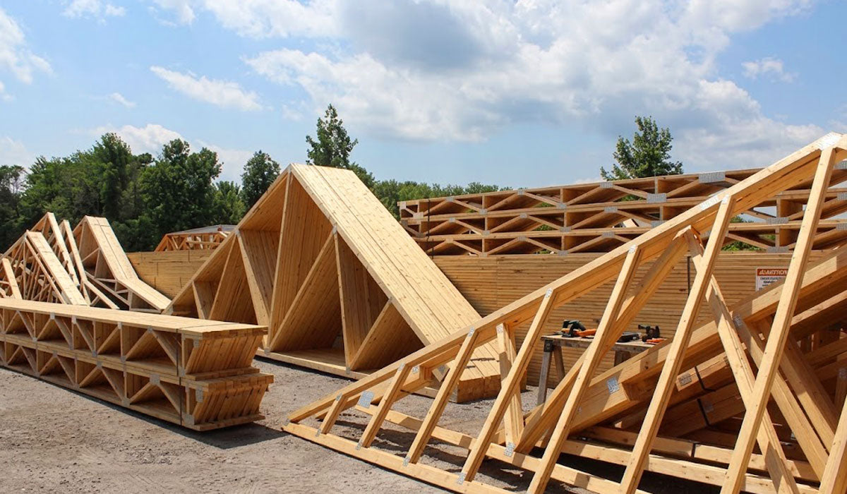 Engineered wood roof trusses bundled and banded for commercial and residential delivery in Temple, TX.