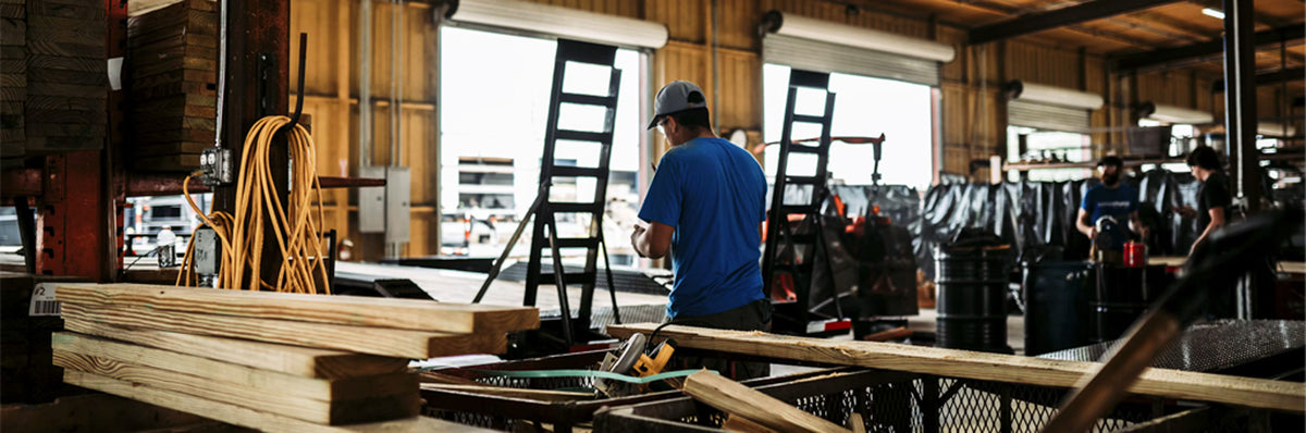 Clear-span engineered wood roof trusses erected across a massive commercial warehouse jobsite in Texas.
